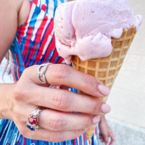 ruby, sapphire and silver and diamond rings on model with ice cream cone and red white and blue background