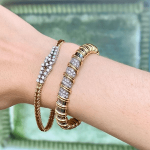 two diamond and gold bracelets on model