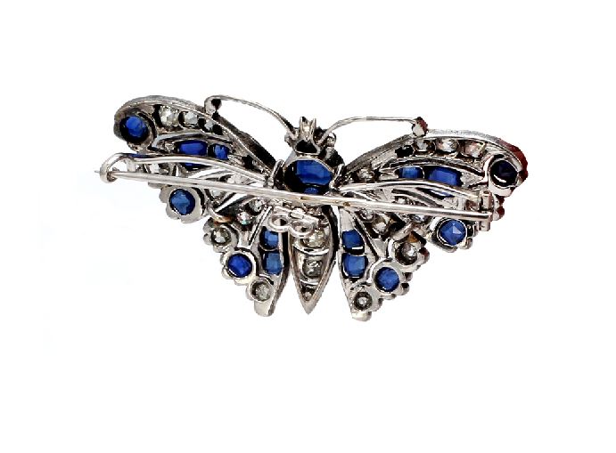 Elegant handcrafted gold butterfly pins with sparkling blue diamonds on  Craiyon