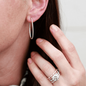 silver and diamond rings and silver earring on model