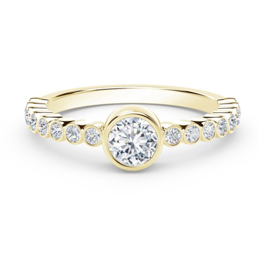 yellow gold diamond ring with bezel set center and smaller bezel set diamonds along the band