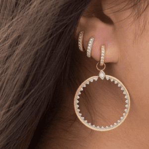 gold and diamond hoop earrings and silver and diamond hoop earring on model