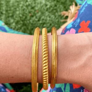 3 gold bracelets on wrist