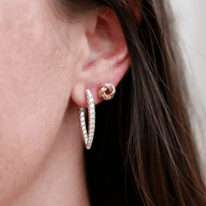 gold earrings on model