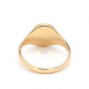 Back view of ring. A polished yellow gold band thickens towards the top as it meets the back of the oval face of this signet ring.