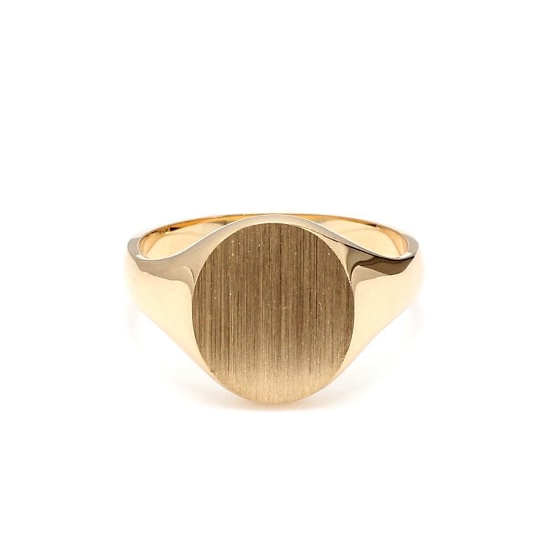 Front view of ring. A polished yellow gold shank thickens towards the top where it meets a brushed oval signet face.