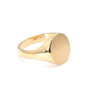 45 degree angle of ring. A polished yellow gold shank thickens towards the top where it meets a brushed oval signet face.