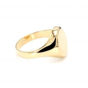 45 degree angle of ring. A polished yellow gold shank thickens towards the top, center where it meets a polished oval signet face.