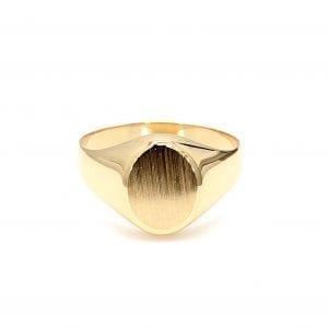Front view of ring. A brushed oval signet face is set along the thickest part of a polished yellow gold tapered shank.
