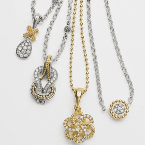 four gold, silver and diamond necklaces with pendants