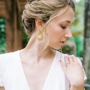 gold earrings on model