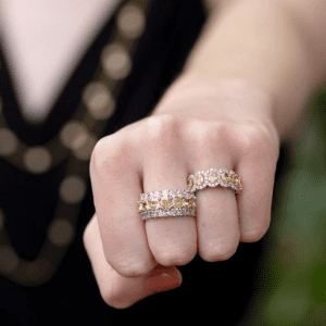 two yellow and white diamond rings on model