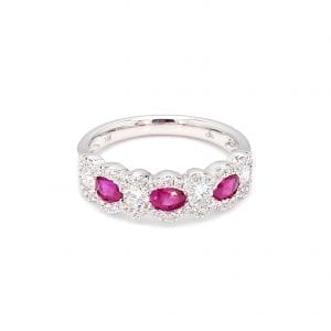 Front view of ring. Three oval cut rubies alternate with round brilliant cut diamonds along the front half of this band with pave diamond scalloped edges.