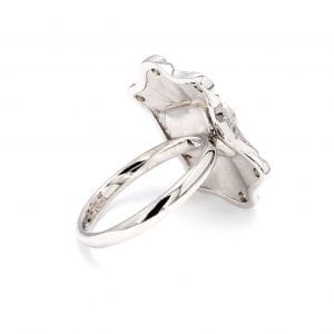 135 degree angle of ring. A simple white gold band is attached to a burst/ ballerina style mounting with no cutouts, solid back. Mounting resembles a shield.