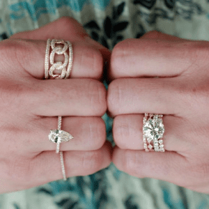 gold and diamond rings on hands
