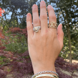 gold and silver bracelets and gold, silver, and diamond rings on model