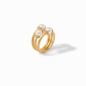 Vertical angle of ring. A set of three. Three stackable rings feature a textured gold plated band with a pearl in the center.