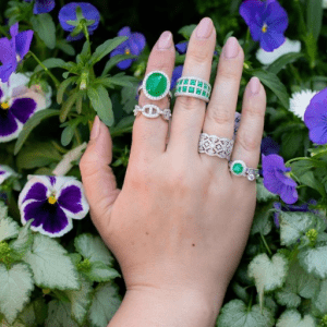 emerald and diamond rings on model