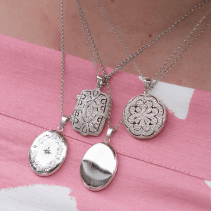 three silver necklaces on model