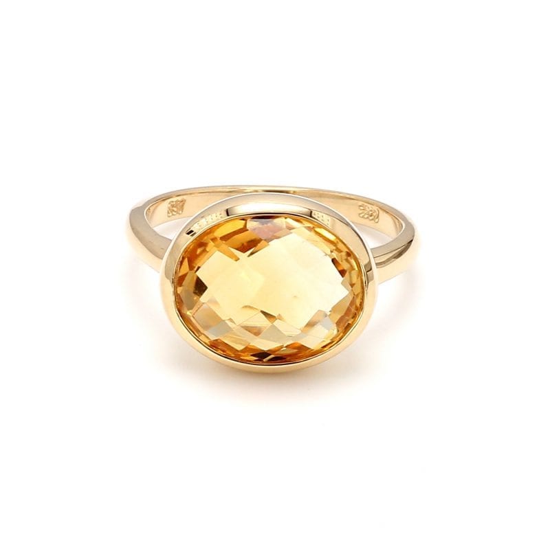 Front view of ring. A polished yellow gold shank boasts a briolette cut oval citrine, set east to west.