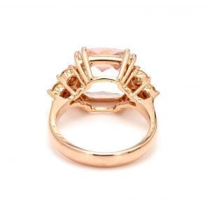 Back view of ring. A simple rose gold shank leads to a cushion shaped setting with shoulders that hold three round brilliant cut diamonds in the shape of a side triangle.