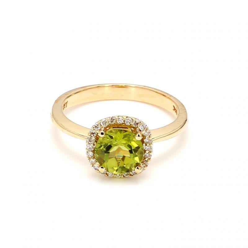 Front view of ring. A center, light green peridot is surrounded by a halo of diamonds, complimented by a polished yellow gold shank.