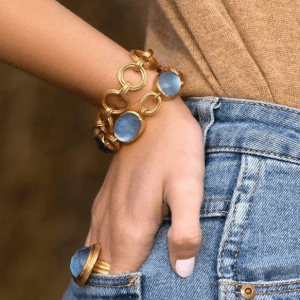 gold bracelets and ring with blue stones on model
