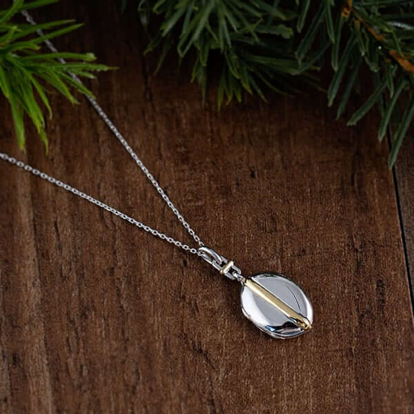 Silver locket on a wood table