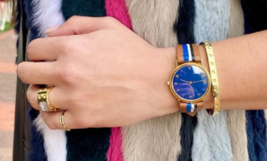 gold bracelet on wrist with watch