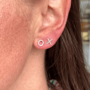 diamond X-O earrings on model