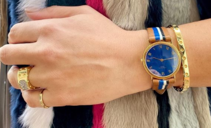 blue watch and gold bracelet on wrist