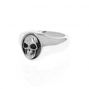 side angle view of silver mens signet ring with gold skull