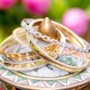 baileys gold and diamond club collection bracelets on decorative urn