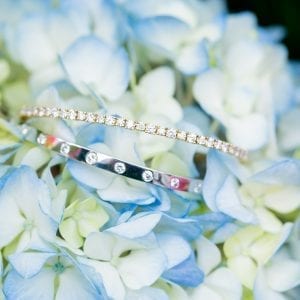 two diamond bracelets on blue flowers