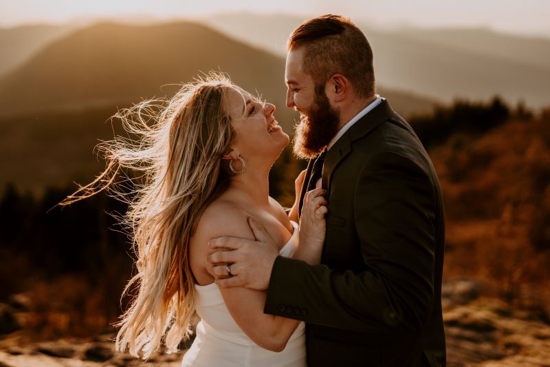 Man and woman hugging on their wedding day in the mountains
