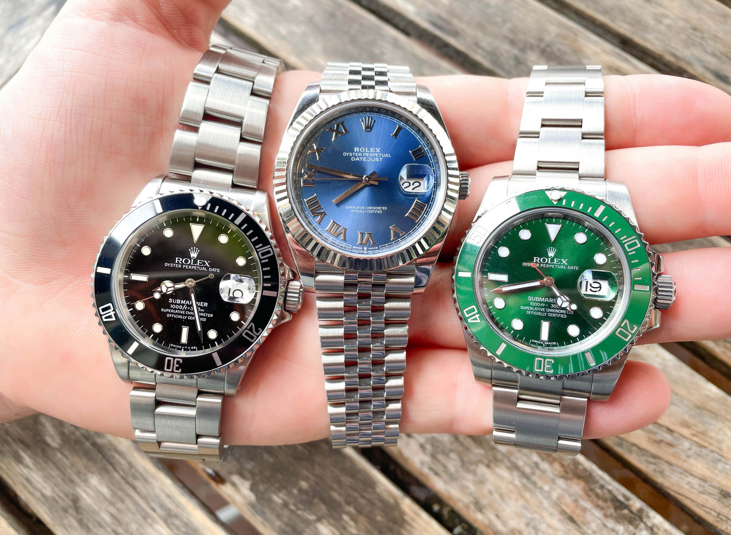 Three Rolex Watches across palm of hand