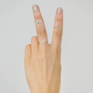 gold pave diamond rings on hand
