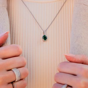 diamond band ring and emerald and diamond pendant necklace