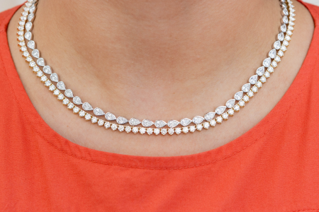 two shapes of tennis necklaces stacked