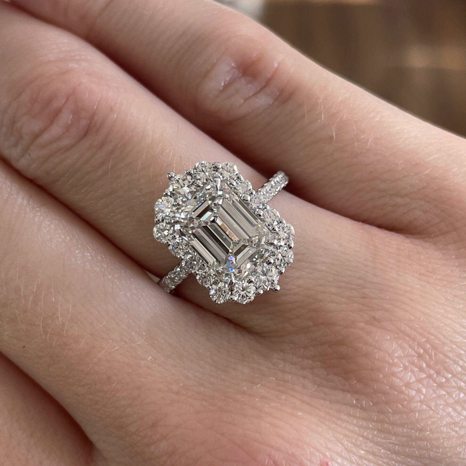 Emerald cut diamond engagement ring with a halo