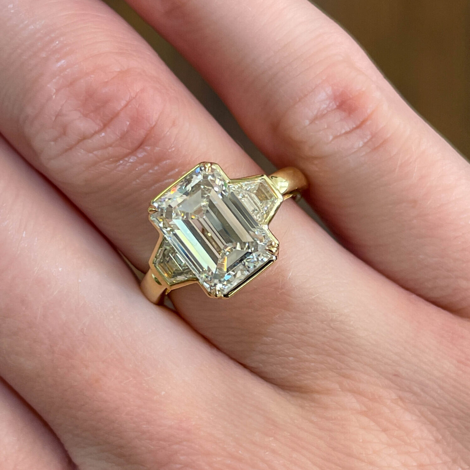 Emerald cut diamond three stone engagement ring.
